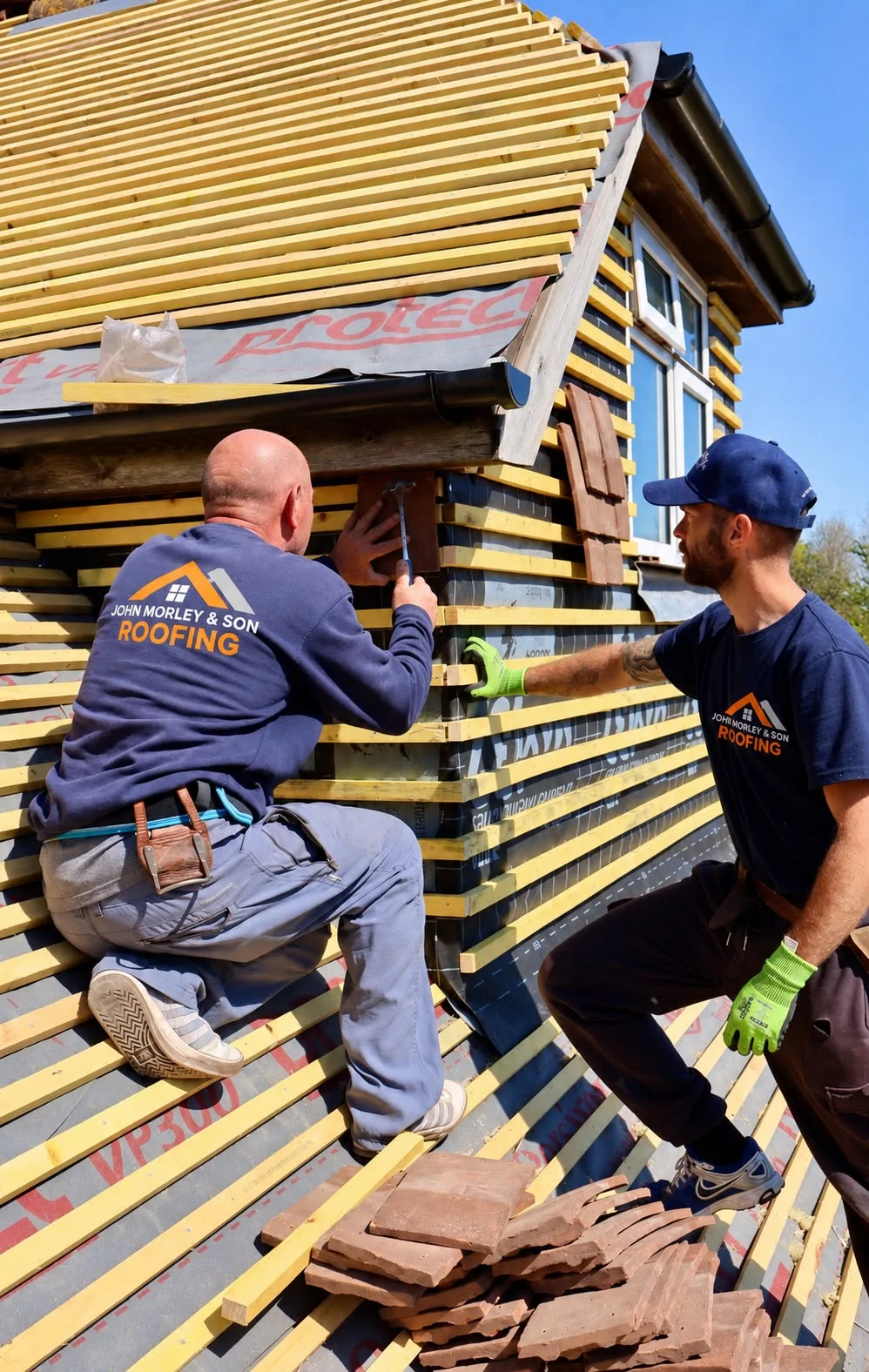 John Morley & Son roofers fixing clay tile hanging to a dormer wall